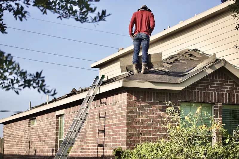 Professional roofer working on a residential roof in The Village of Baytowne Wharf